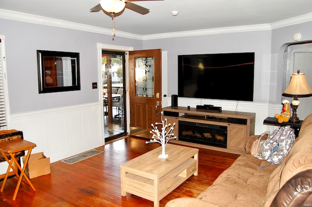 living room featuring crown molding, ceiling fan, and dark hardwood / wood-style flooring