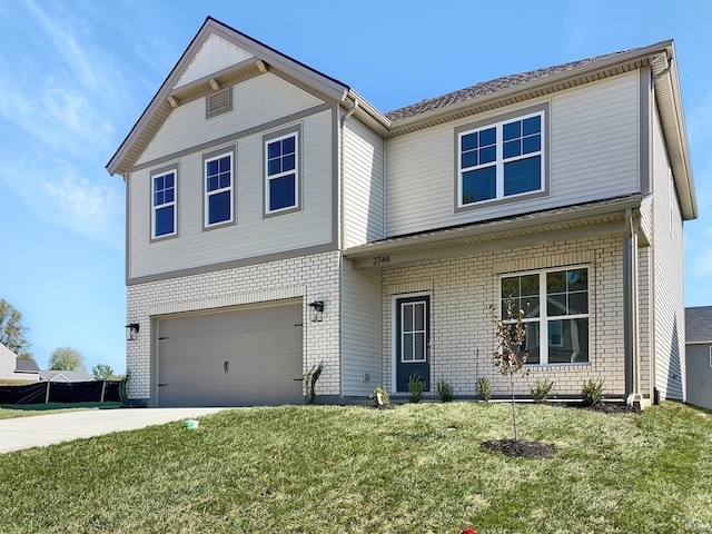 view of front of property with a garage and a front lawn