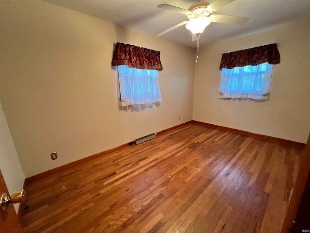 unfurnished room with ceiling fan, plenty of natural light, and wood-type flooring