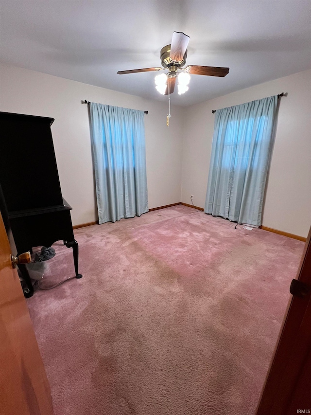 carpeted empty room featuring ceiling fan