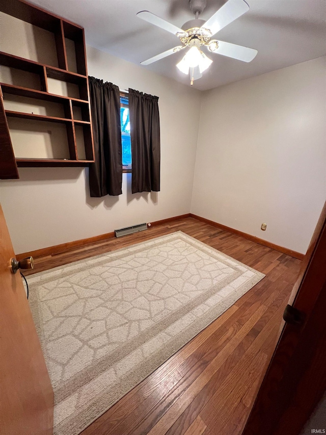 unfurnished room with hardwood / wood-style flooring and ceiling fan