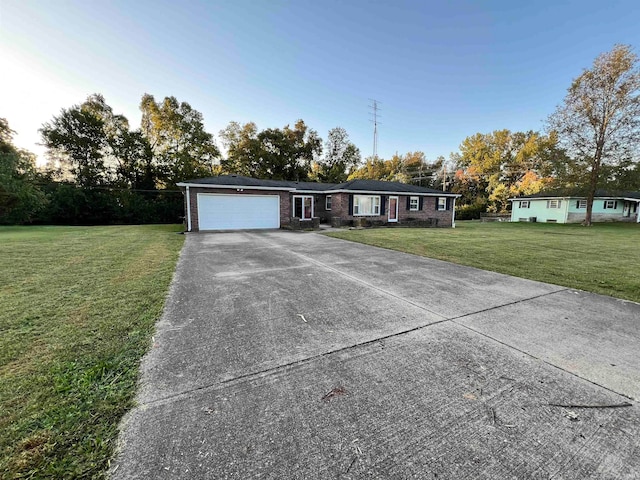 single story home featuring a front lawn and a garage