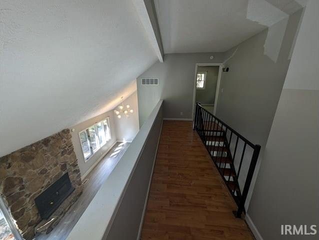 hallway featuring vaulted ceiling with beams and dark hardwood / wood-style floors