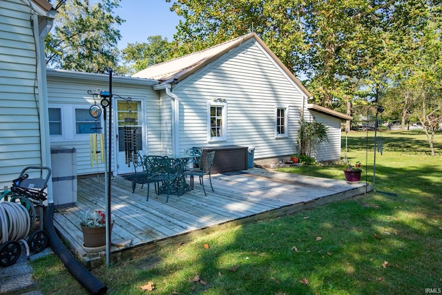 wooden terrace featuring a lawn