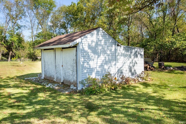 view of outdoor structure featuring a lawn