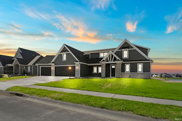 craftsman inspired home with a garage and a yard