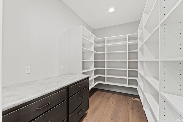 spacious closet with light hardwood / wood-style floors