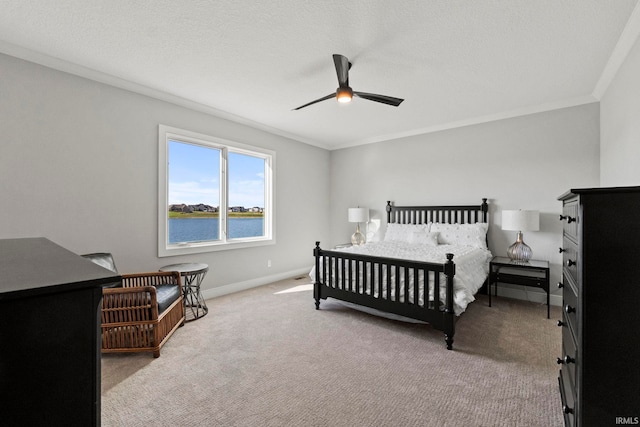 bedroom featuring ceiling fan, crown molding, light carpet, and a water view