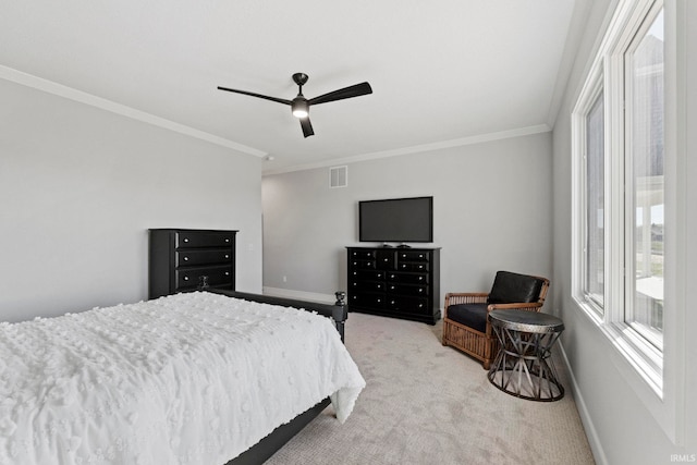 bedroom featuring light carpet, ornamental molding, and ceiling fan