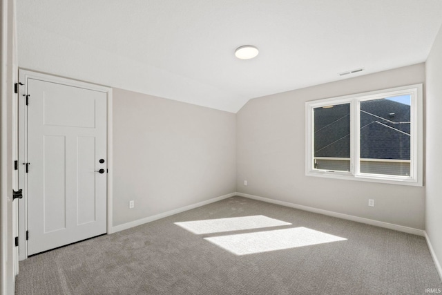 bonus room featuring light carpet and vaulted ceiling