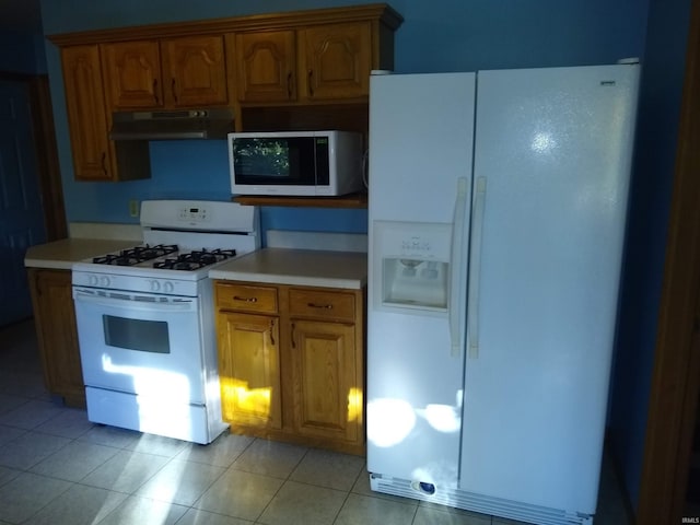 kitchen with light tile patterned floors and white appliances