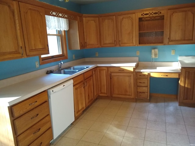 kitchen with light tile patterned floors, white dishwasher, and sink