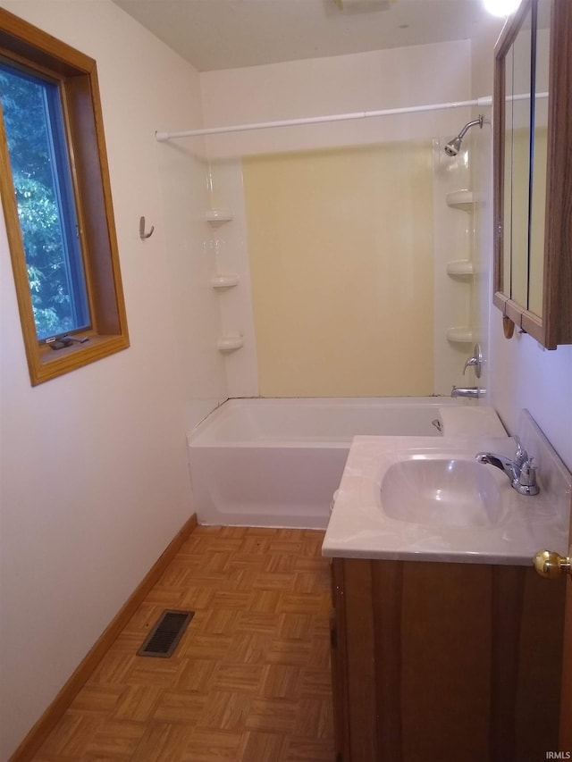 bathroom with washtub / shower combination, parquet floors, and vanity