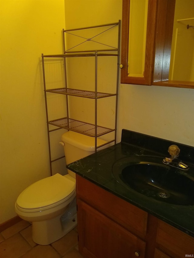 bathroom featuring tile patterned floors, vanity, and toilet