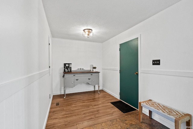 washroom featuring hardwood / wood-style flooring and a textured ceiling