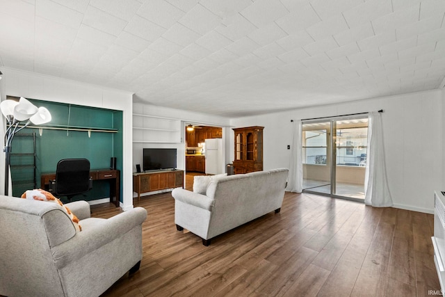 living room featuring hardwood / wood-style flooring and built in features