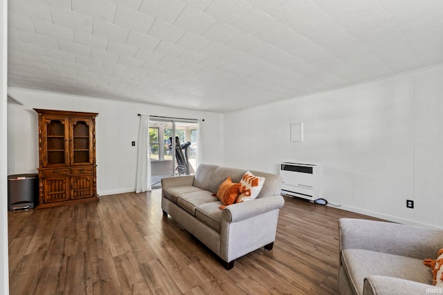 living room with dark wood-type flooring and heating unit