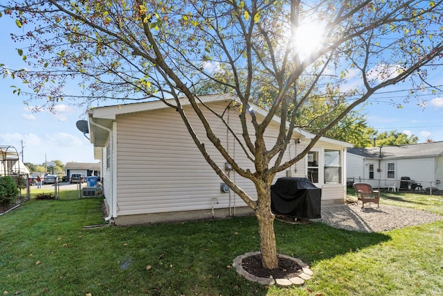 back of property featuring central AC unit and a lawn