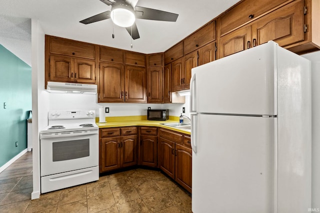 kitchen featuring ceiling fan, white appliances, and sink