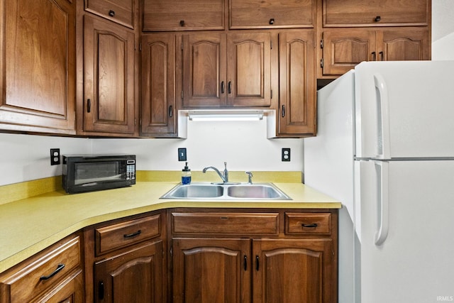 kitchen featuring sink and white fridge