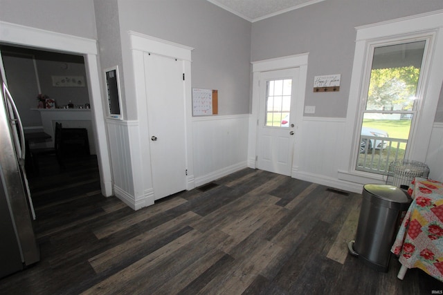 entryway featuring crown molding, dark hardwood / wood-style flooring, and a textured ceiling