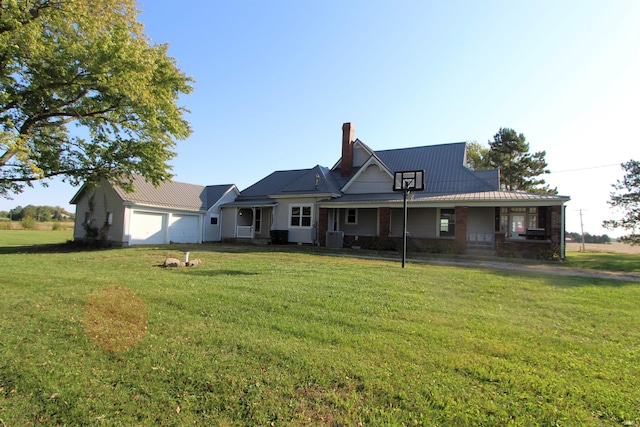 view of front of home featuring a porch, cooling unit, a front yard, and a garage