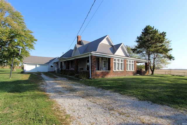 view of side of property featuring a porch, a lawn, and a garage