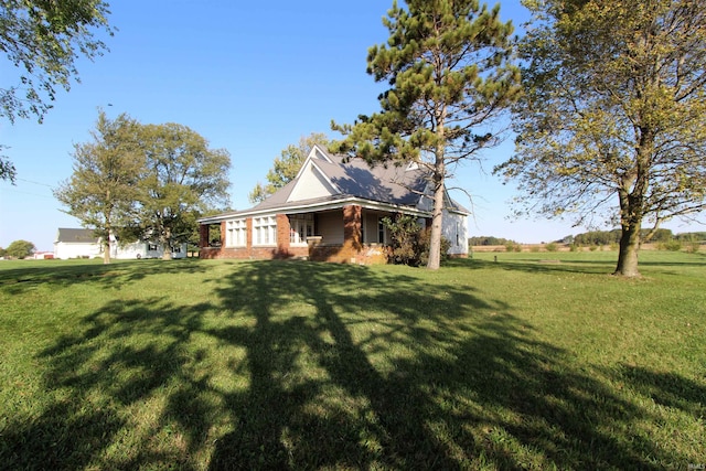 view of side of home with a lawn