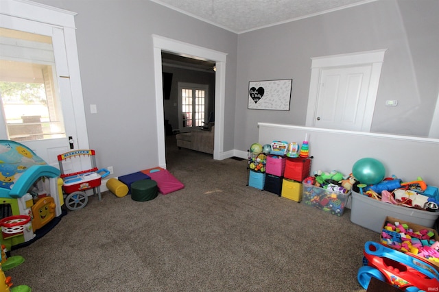 playroom featuring carpet floors and a textured ceiling