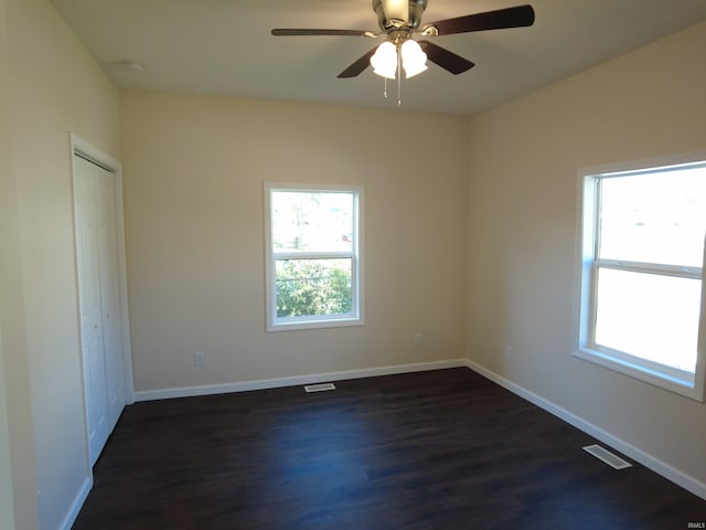 spare room featuring ceiling fan and dark hardwood / wood-style floors