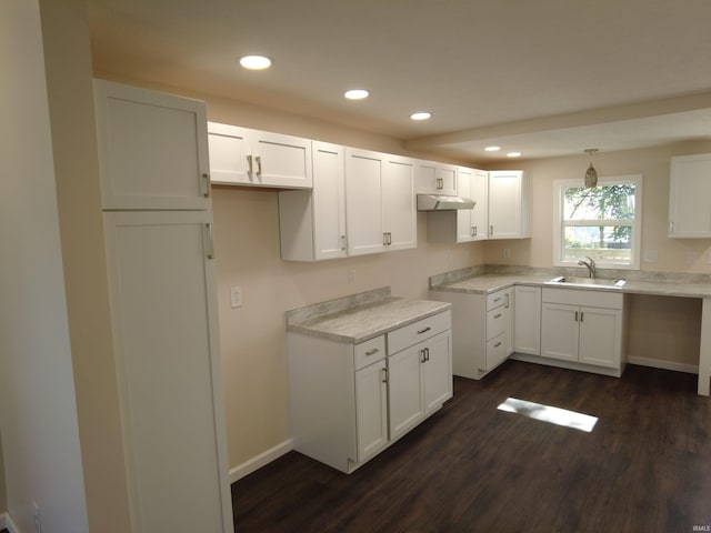 kitchen with pendant lighting, white cabinetry, sink, and dark hardwood / wood-style floors