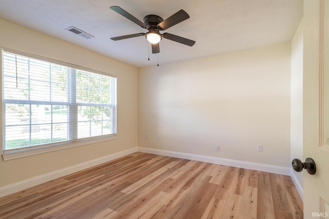 empty room with light wood-type flooring and ceiling fan