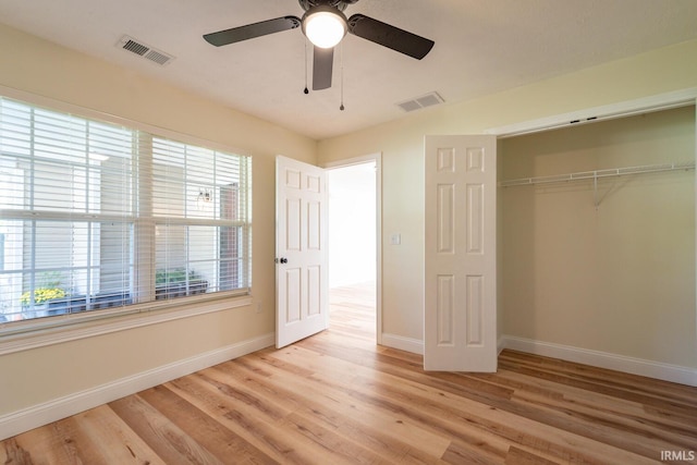 unfurnished bedroom featuring ceiling fan, a closet, and light hardwood / wood-style flooring