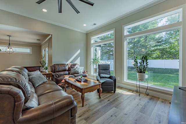 living room featuring ornamental molding, ceiling fan, and light hardwood / wood-style flooring