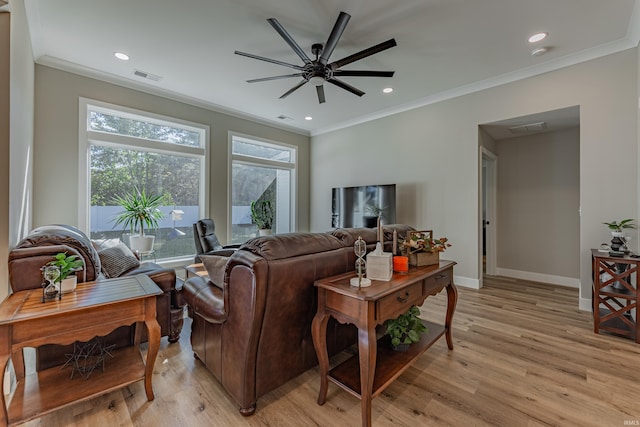 living room featuring light hardwood / wood-style flooring, ornamental molding, and ceiling fan