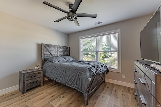 bedroom with ceiling fan and light hardwood / wood-style floors