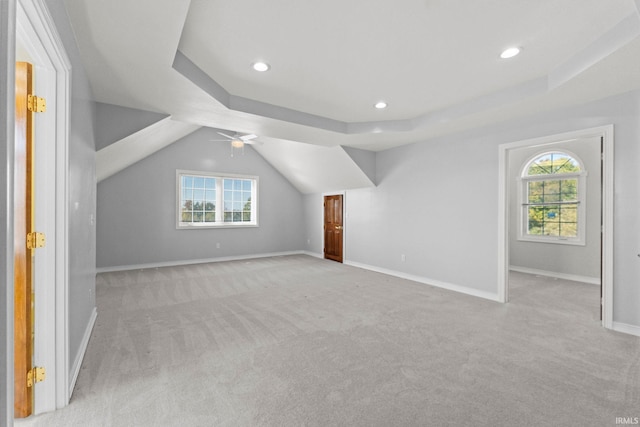 additional living space featuring light carpet, vaulted ceiling, and ceiling fan