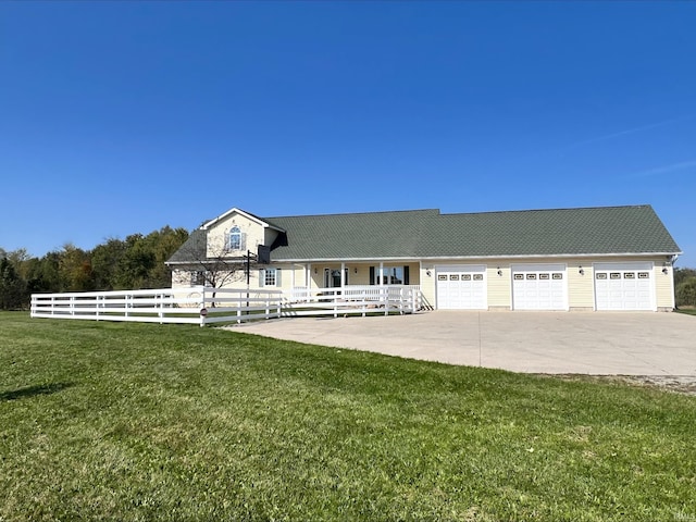 view of front of house featuring a garage and a front lawn