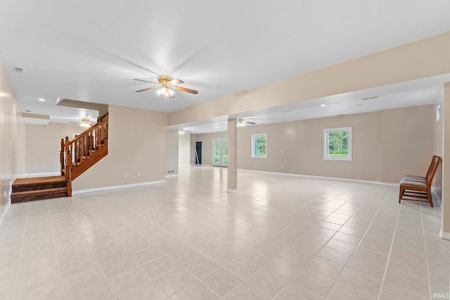 unfurnished living room with ceiling fan and light tile patterned floors