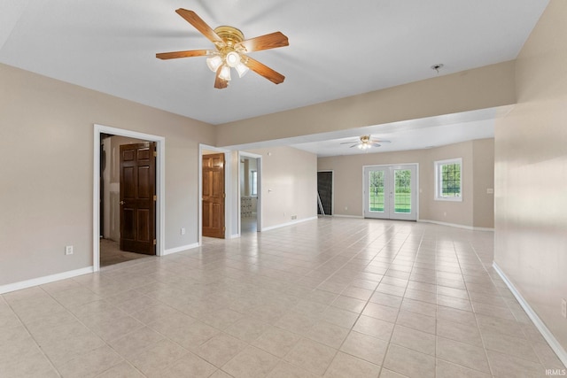 tiled spare room with ceiling fan