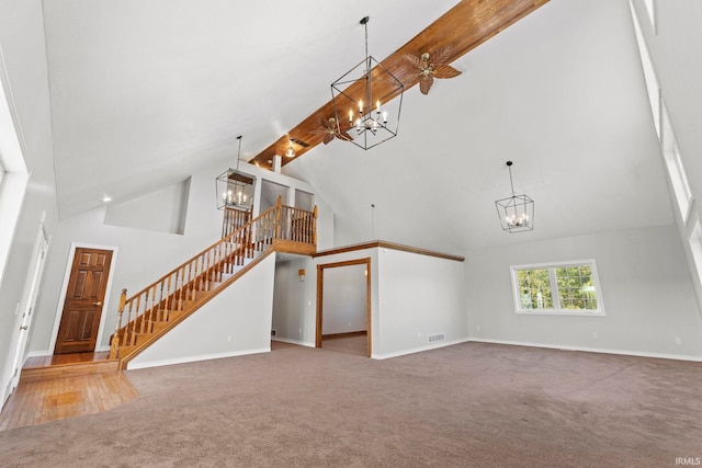 unfurnished living room with beam ceiling, carpet, and high vaulted ceiling