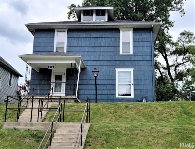 view of front of house with a porch and a front yard