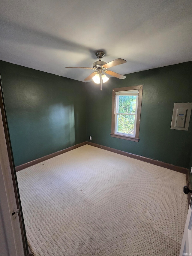 carpeted empty room featuring ceiling fan