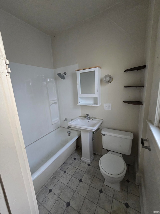 bathroom featuring shower / bathtub combination and toilet