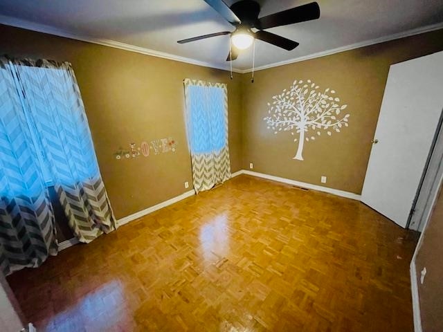 spare room with crown molding, ceiling fan, and parquet floors