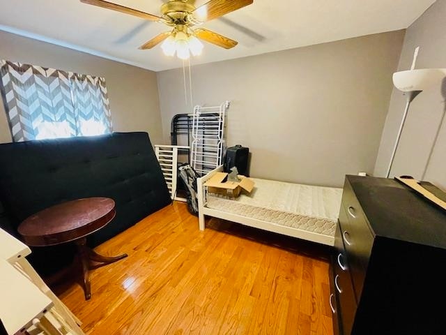 bedroom featuring light wood-type flooring and ceiling fan