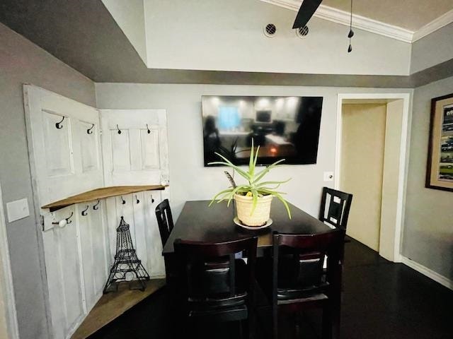 dining room with crown molding and vaulted ceiling