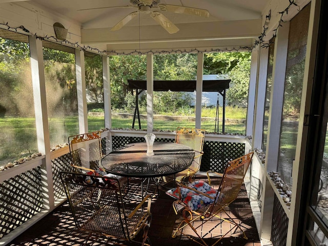 sunroom / solarium featuring ceiling fan