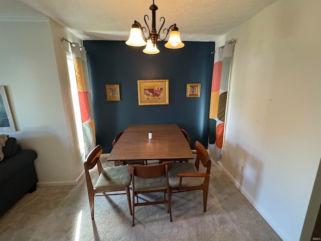 dining room with an inviting chandelier, a textured ceiling, a wealth of natural light, carpet floors, and crown molding