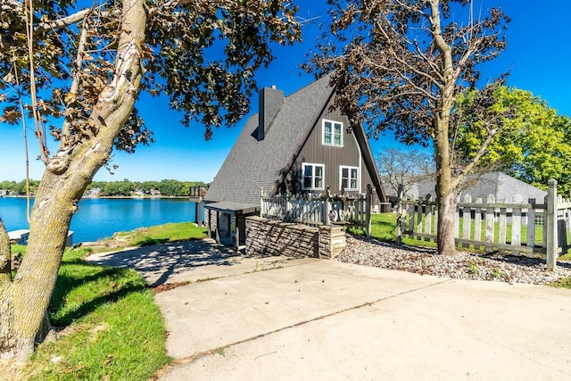 view of front of house with a water view